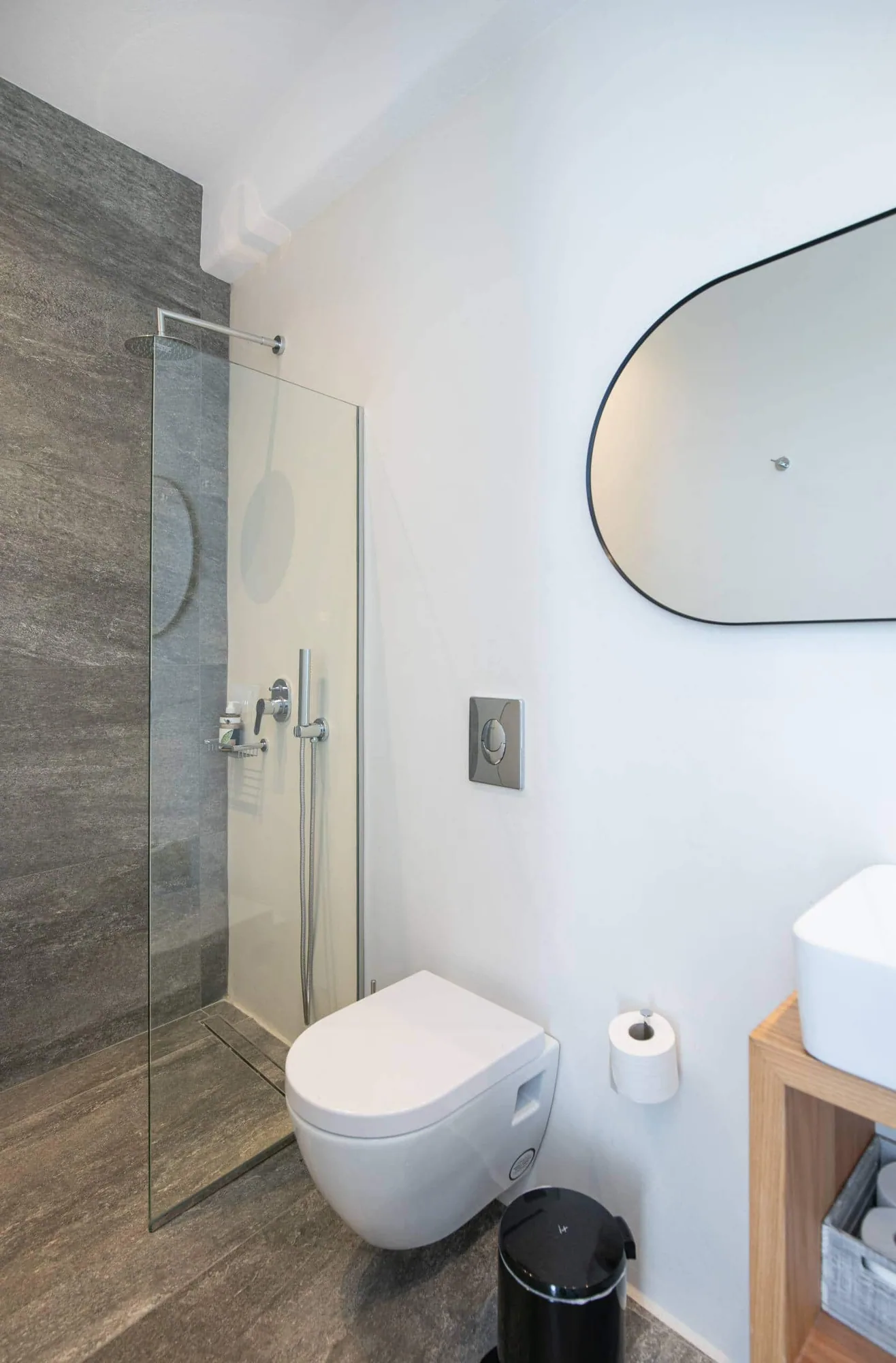 Bathroom with oval mirror and walk-in shower